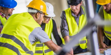 Construction workers checking utility plans